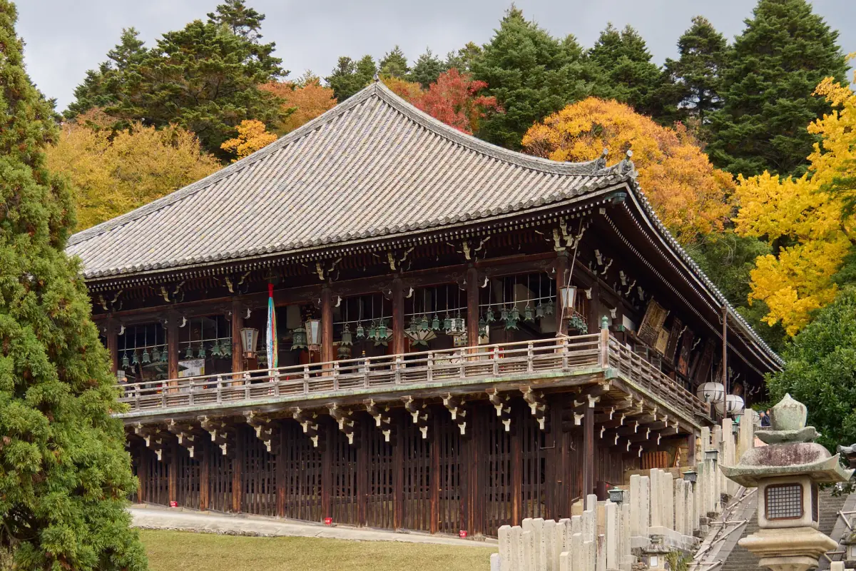 A temple hall among autumn trees